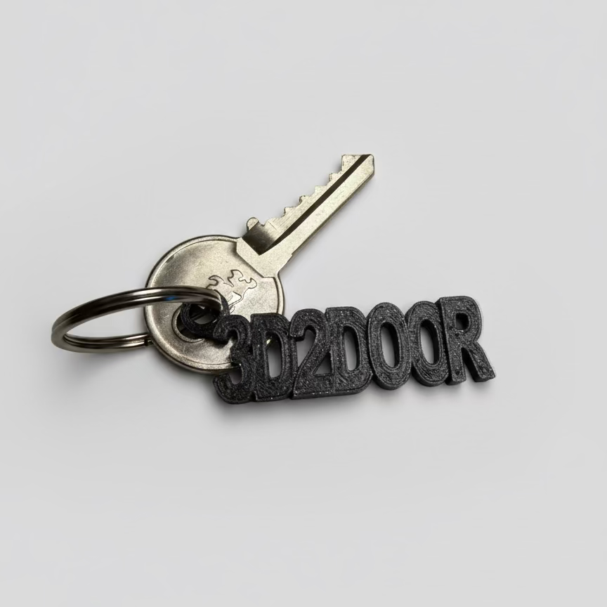 Keychain with a key and '3D2DOOR' lettering on a light gray background
